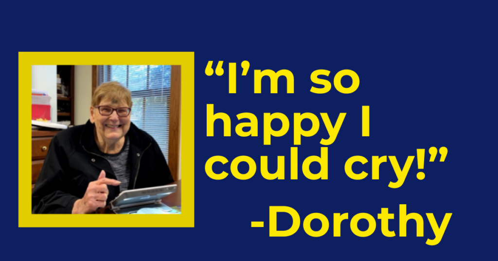 Woman with digital magnifier. TEXT: "I'm so happy I could cry" - Dorothy