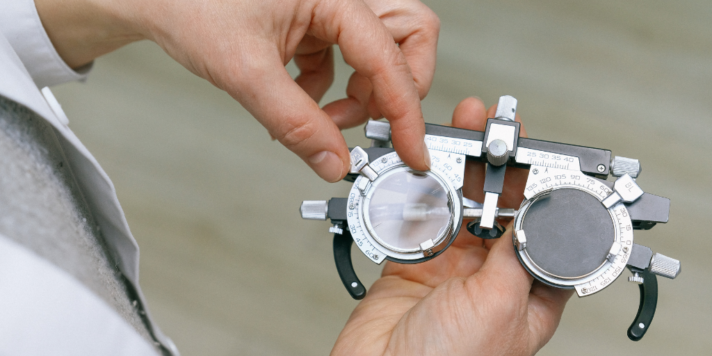 a optometrist is holding a pair of eyeglasses