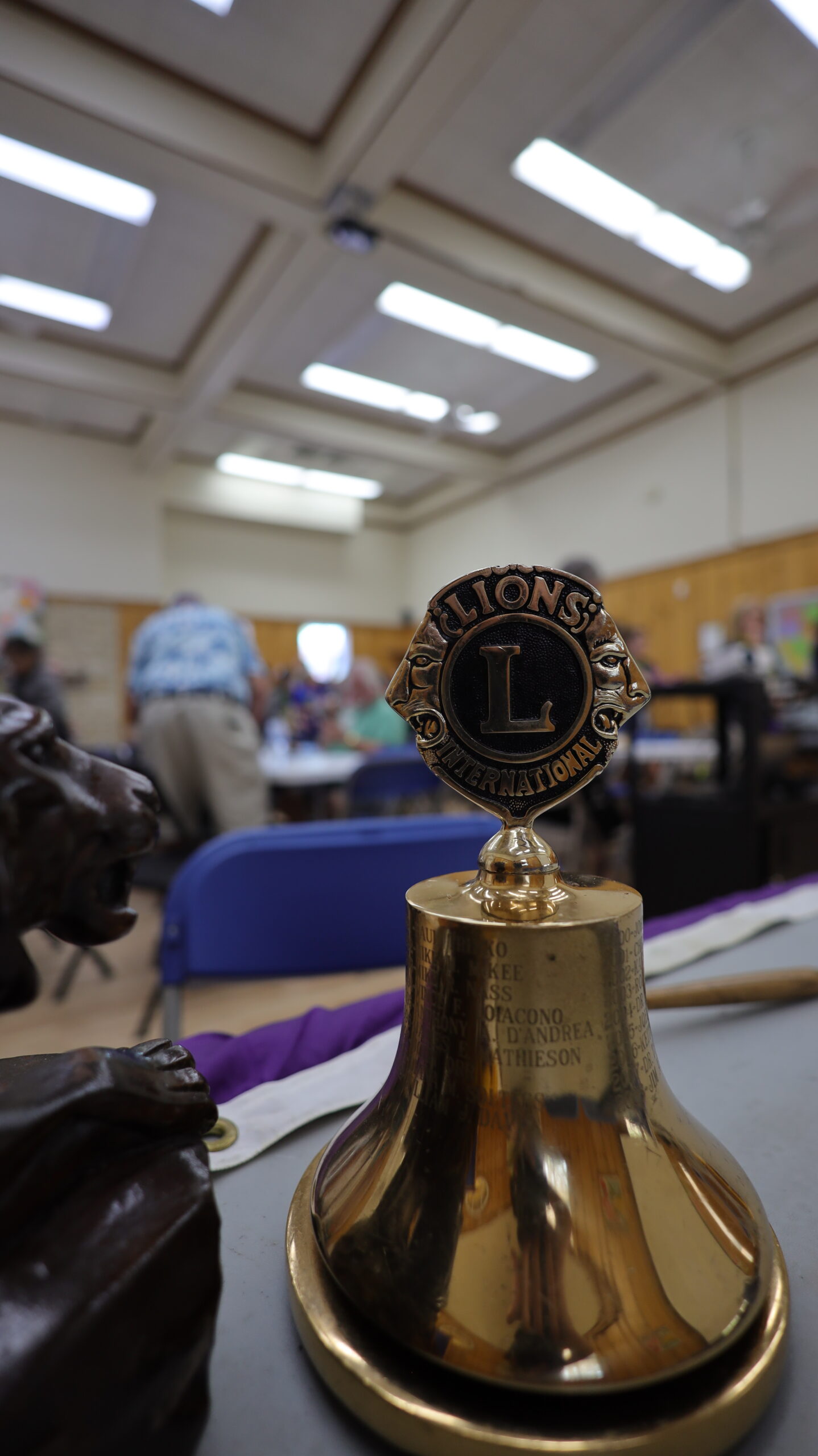 a golden bell with a Lions emblem on top.