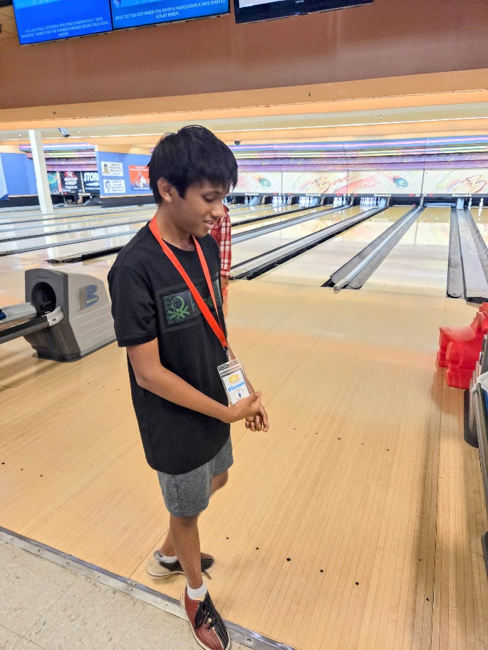 A Trip to Cosley Zoo with Grandma Martyl's Low Vision Day Camp 33 a young person standing by a bowling lane.